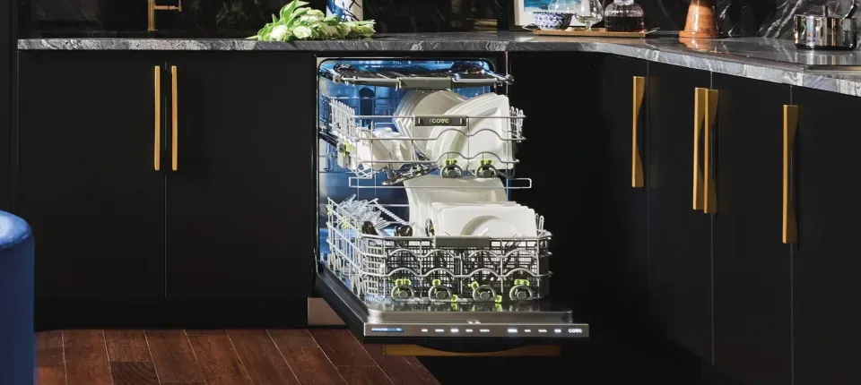 Open Cove branded dishwasher loaded with clean dishes in a dark modern kitchen with dark cabinetry.